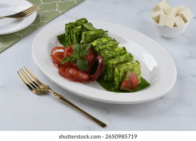 Paneer tikka with green marinade and spices, served with mint chutney